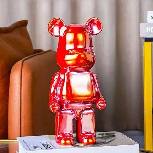 A glossy red translucent bearbrick piggy bank with smooth reflective surface as a cabinet sculpture decor for living room