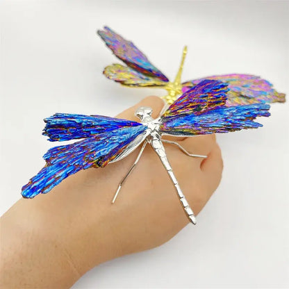 A vibrant iridescent blue and purple crystal dragonfly brooch made of metallic material for decorative figurines decorbites