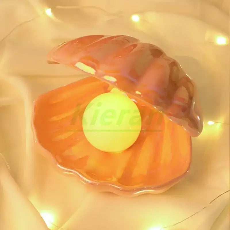 Glossy orange ceramic clamshell holding a bright yellow sphere iridescent led night light for bedroom use