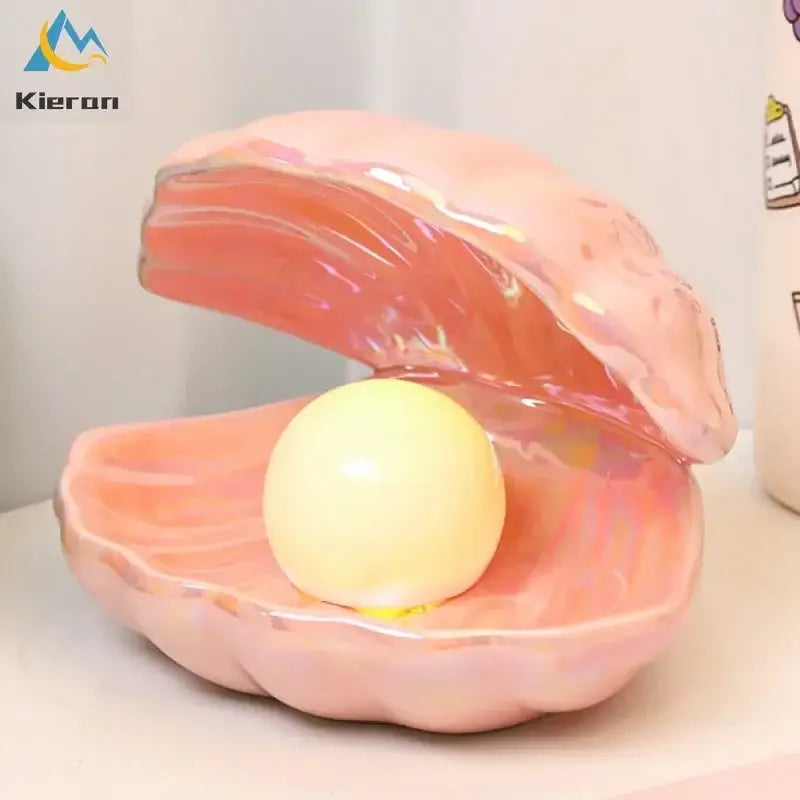 Pink iridescent ceramic clamshell led night light featuring a smooth pale yellow pearl for bedroom use