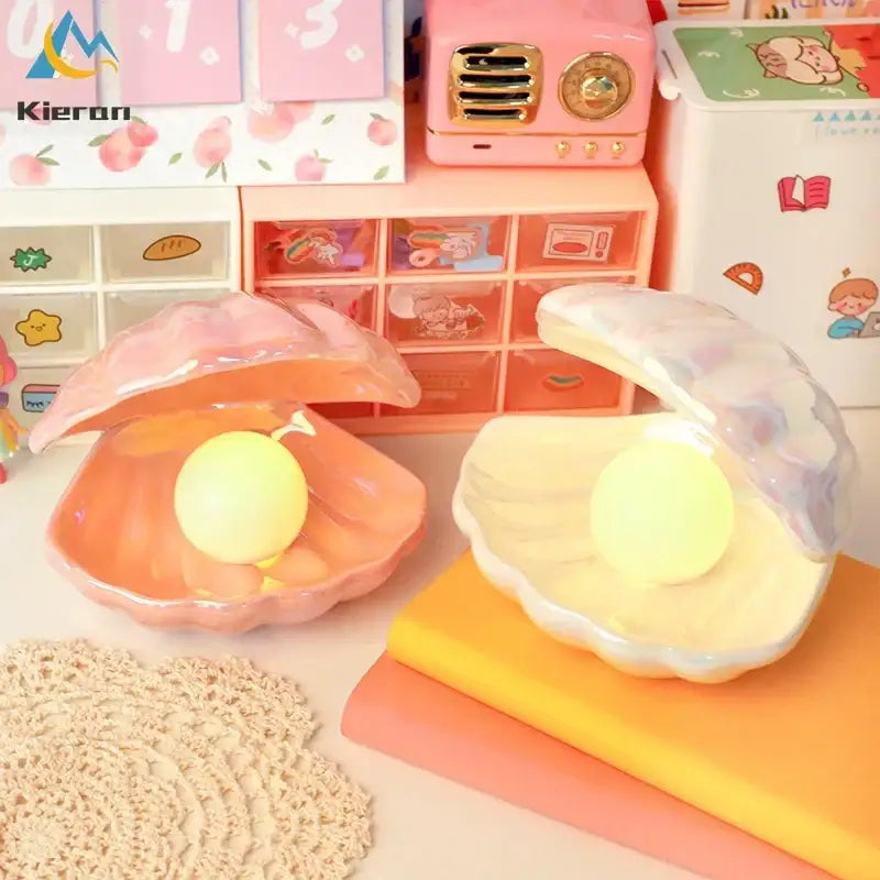 Pink and white iridescent ceramic shell led night light with translucent clamshell organizer holding yellow spheres