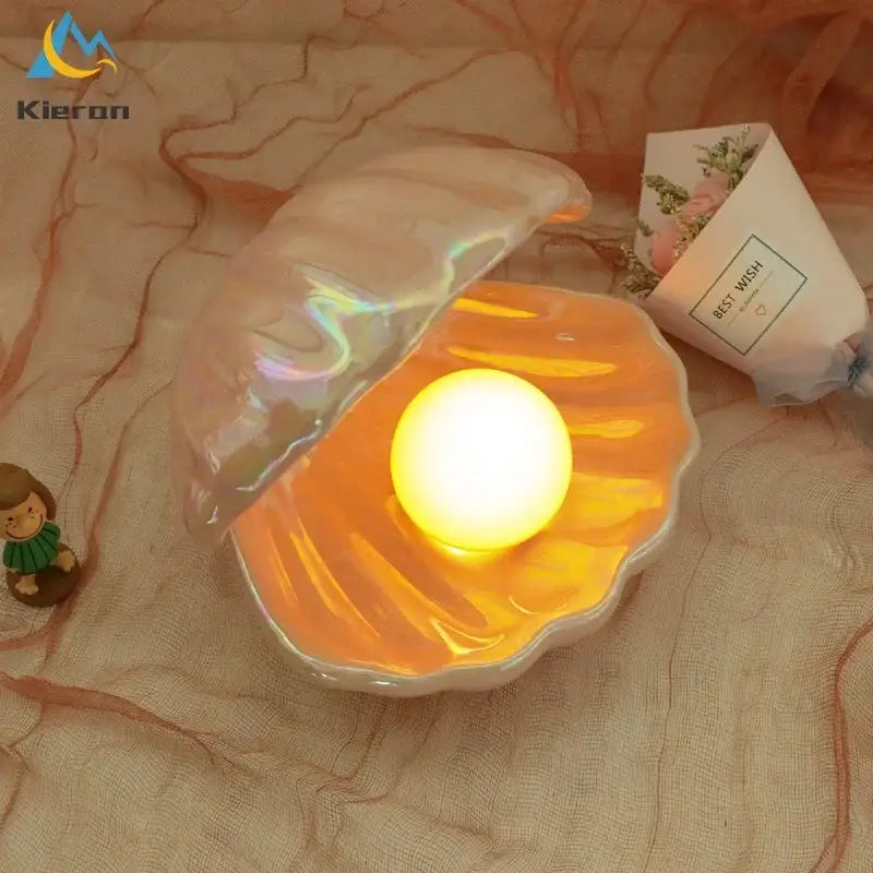 Iridescent ceramic shell led night light with glowing yellow orb for bedroom illumination and decorative use
