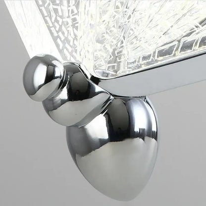 Chrome finished acorn shaped wall sconce with textured crystal glass shade complements decorbites butterfly pendant lights