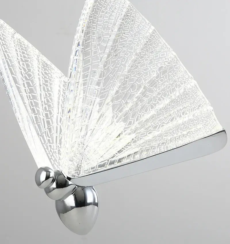 A modern butterfly pendant light with iridescent gold crackled glass wings and polished chrome base for decorbites butterfly decor