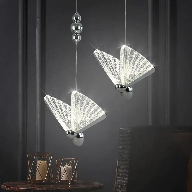 Two elegant silver-finished decorbites butterfly pendant lights with crystal-like wings for bedroom and living room decor