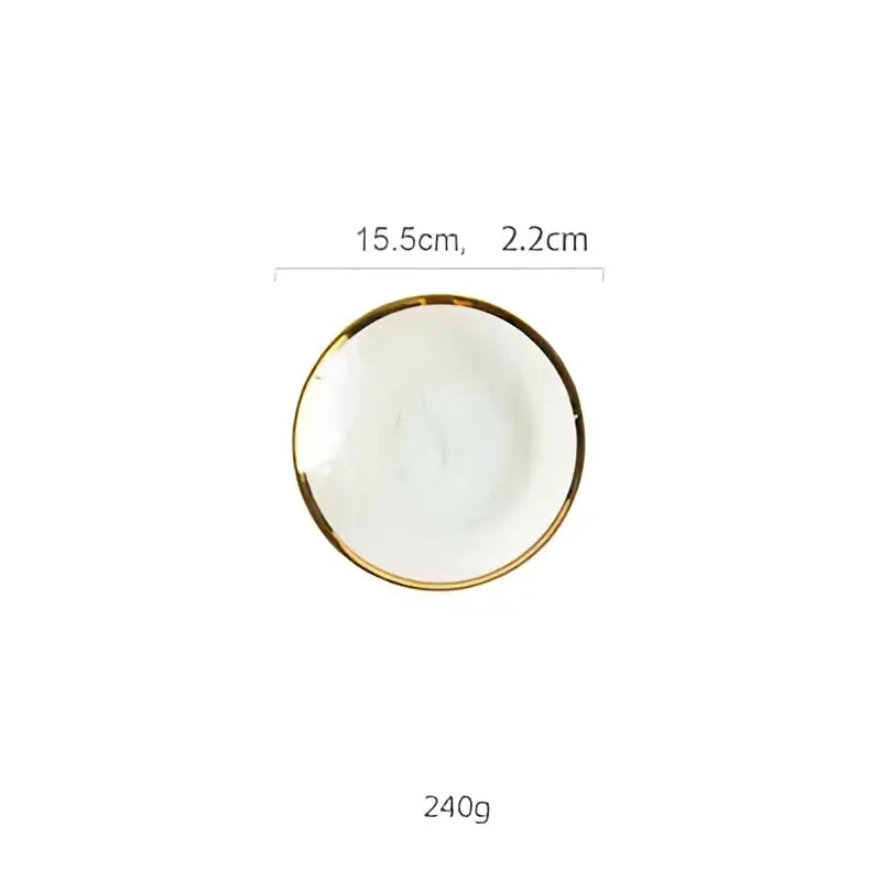 A small white ceramic salad bowl with a delicate gold rim complementing iridescent gold rim glass salad bowl tableware