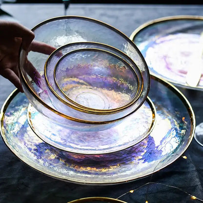 Set of iridescent glass salad bowls with gold rims stacked on matching plates for elegant dining room tableware
