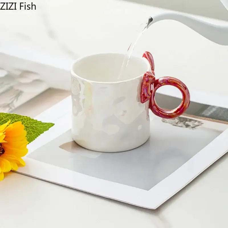 White ceramic coffee mug with bowknot glazed iridescent finish and vibrant red fish tail handle decorbites bowknot glazed