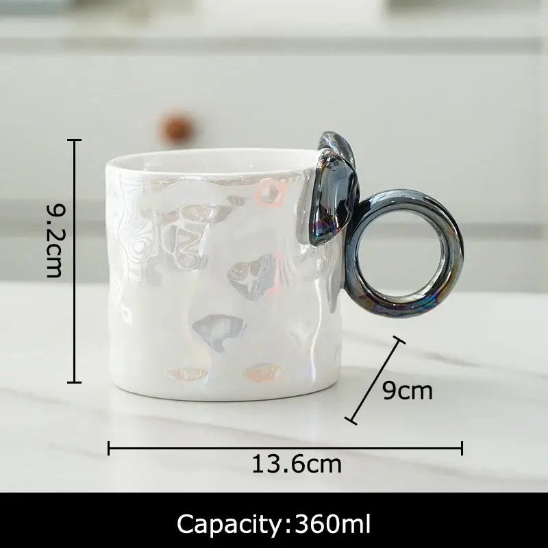 White ceramic coffee mug with iridescent bowknot glazed finish and metallic silver ring handle by decorbites bowknot glazed