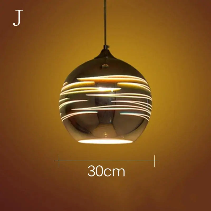 A sleek spherical glass pendant light with reflective black finish and warm yellow glowing stripes for living room decor