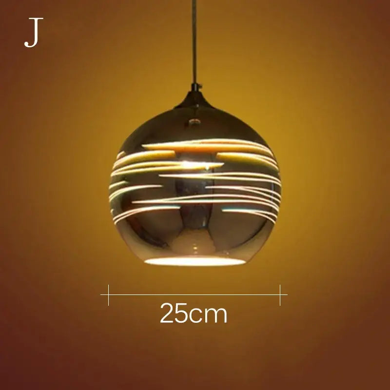 Spherical iridescent starburst glass pendant light with reflective dark metallic finish and glowing concentric stripes