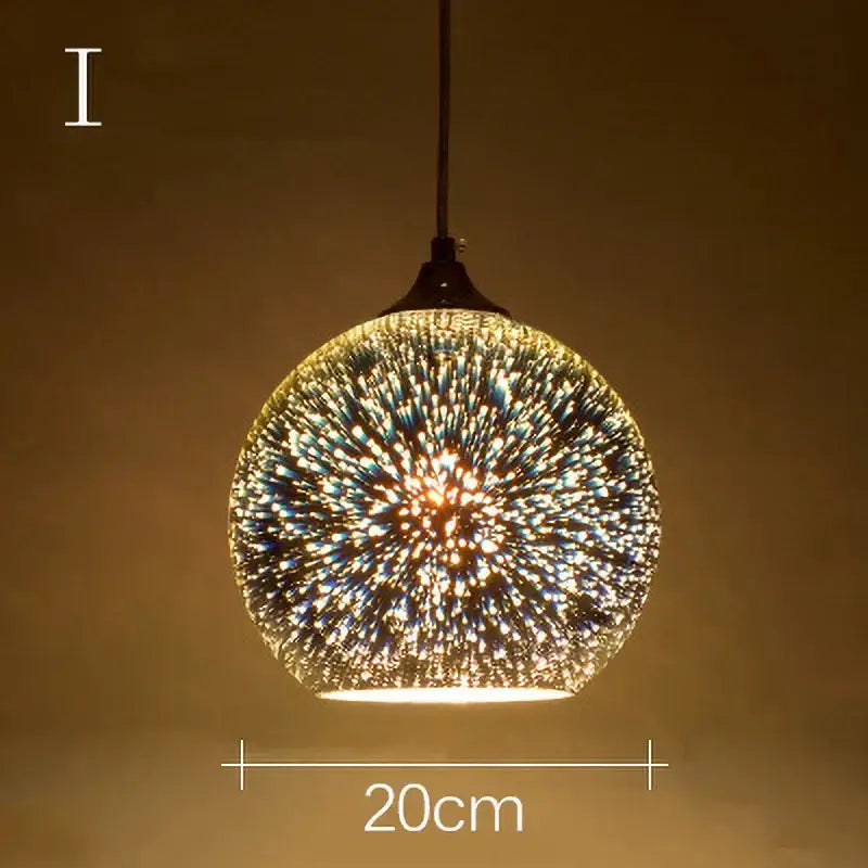 A spherical glass pendant light with iridescent gold and blue starburst design for living room decor