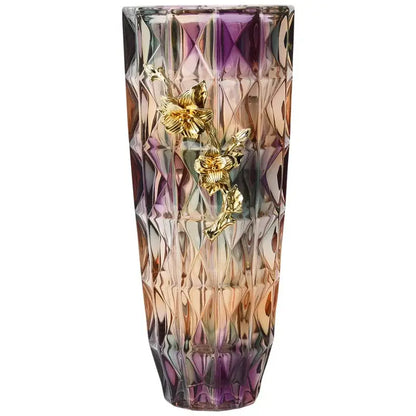 A tall faceted crystal glass vase with purple and amber gradient and three golden floral embellishments
