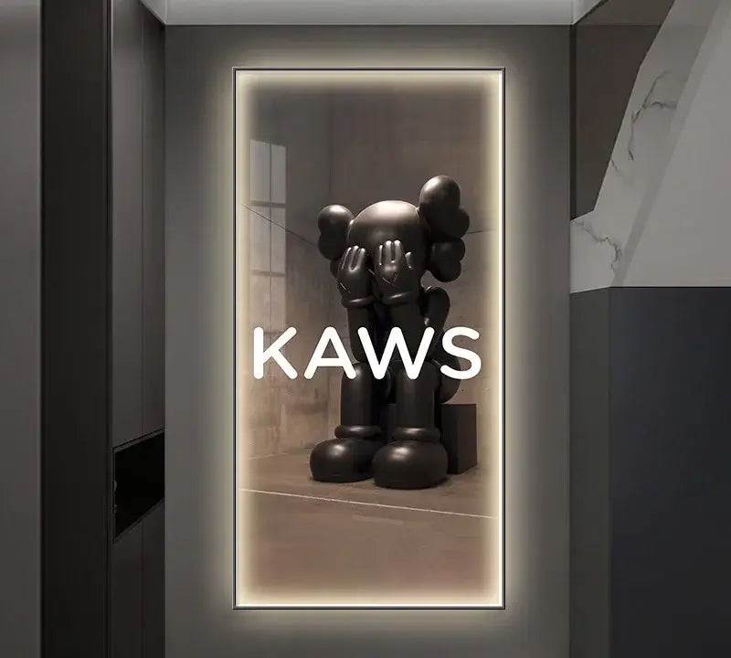 Black kaws sculpture with oversized hands covering its eyes displayed in a sleek framed mirror led wall lamp decor