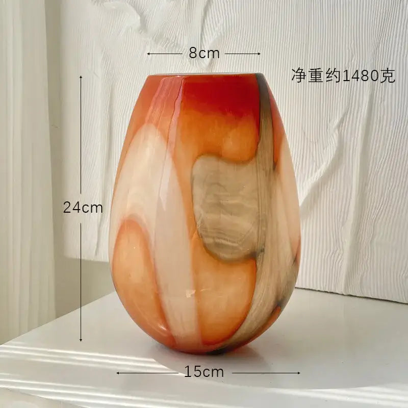 A glossy teardrop-shaped glass vase with swirling orange red and beige gradients for irregular geometric decorbites decor