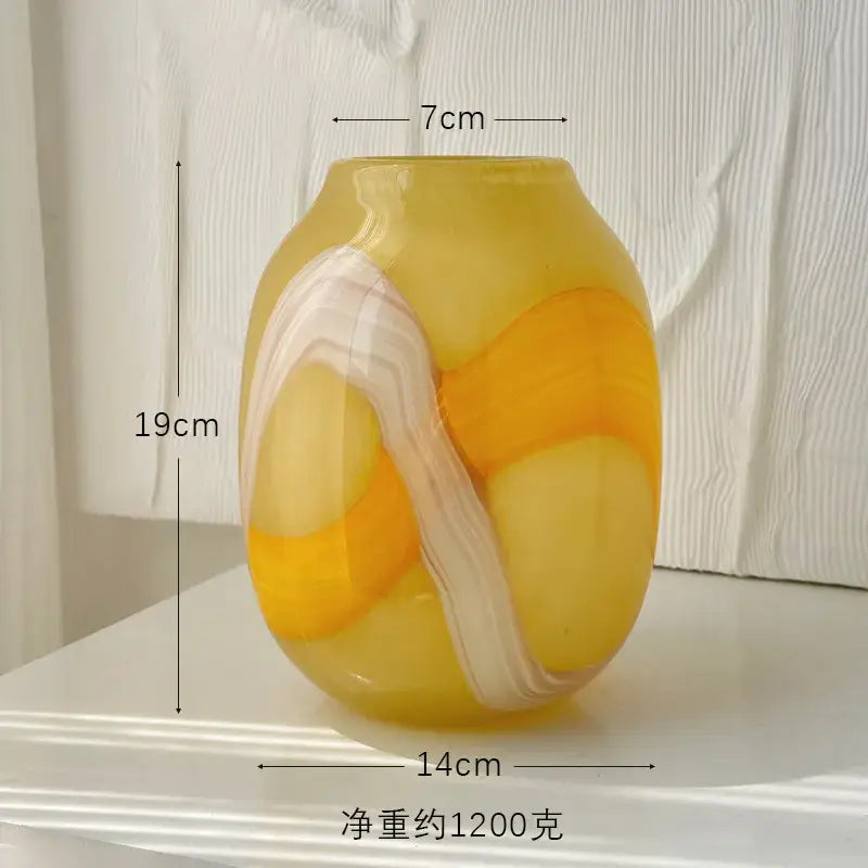 A translucent yellow and white marbled glass vase with a rounded shape for irregular geometric graffiti decorbites decor