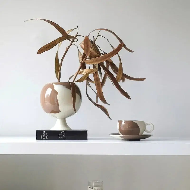 A sleek two-toned irregular grain spherical ceramic vase with glossy pink and white design for living room decor
