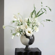 A sleek black and white ceramic irregular grain spherical vase with calla lilies for living room decorbites decor