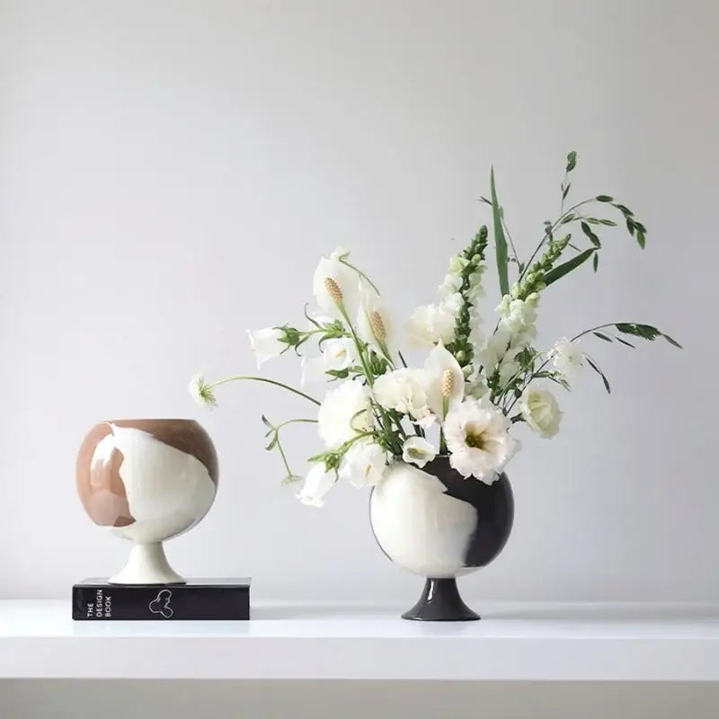 Two ceramic irregular grain spherical vases in black white and muted brown decorbites irregular grain living room decor