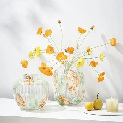 Clear glass vase with irregular ribbed vertical ridges and swirling amber green and white patterns for living room decor