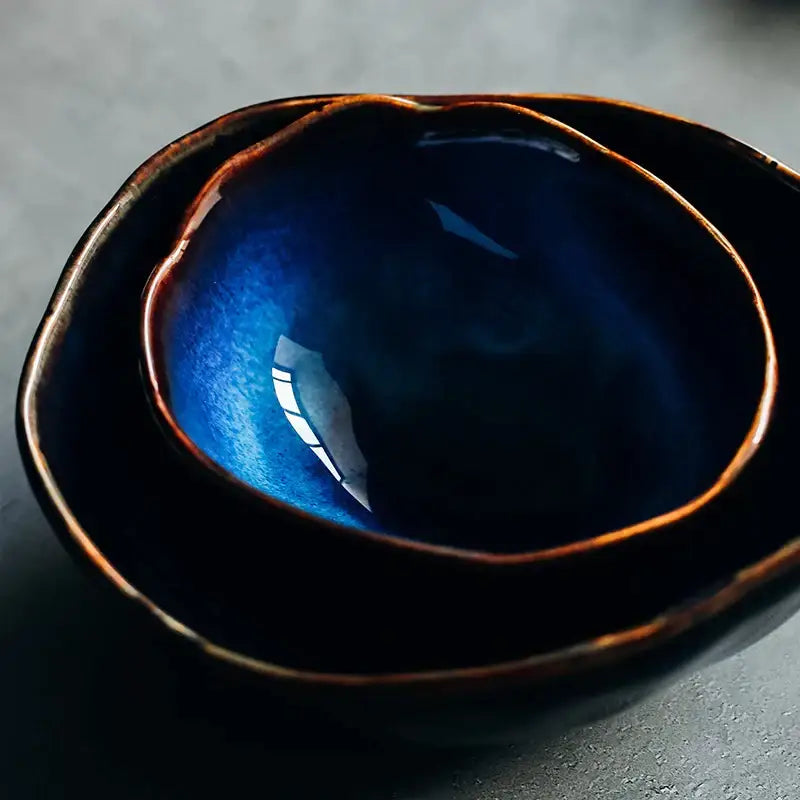 Deep blue irregular shape ceramic bowl with handcrafted finish and warm brown rim from decorbites dinner set
