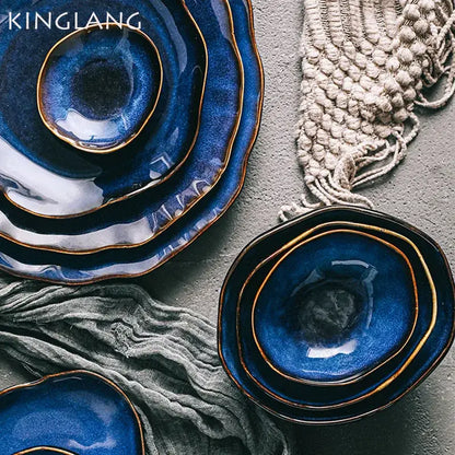 Deep cobalt blue ceramic dinner set with irregular shape and gold-rimmed edges by decorbites for dining room use