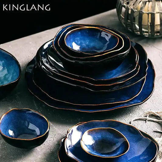Deep cobalt blue ceramic dinner set with irregular shape rims and gold-trimmed edges by decorbites irregular shape