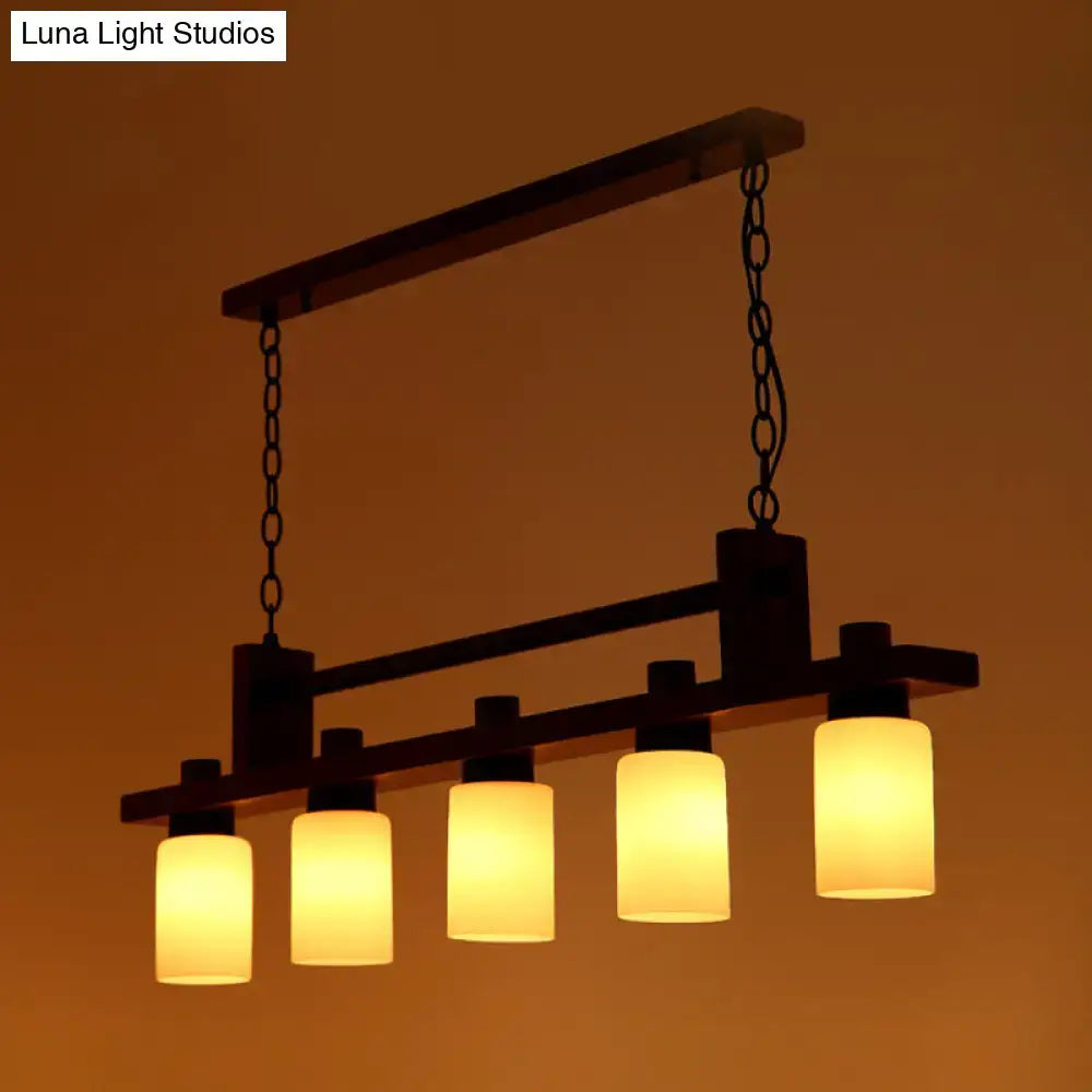 Decorbites™ 5-light island pendant features warm opal glass shade with traditional linear wood frame in brown finish