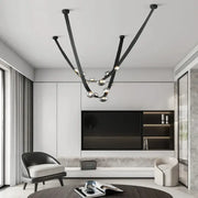 Black metal chandelier with sleek curved arms and spherical glass bulbs for italian light luxury dining room decorbites italian light