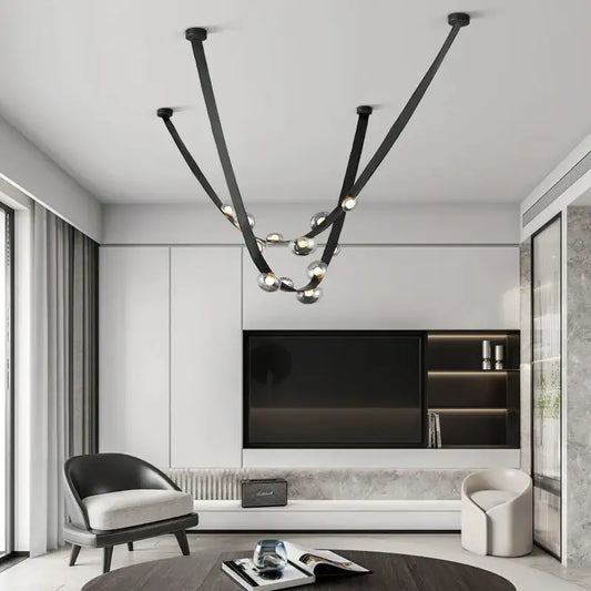 Black metal chandelier with sleek curved arms and spherical glass bulbs for italian light luxury dining room decorbites italian light