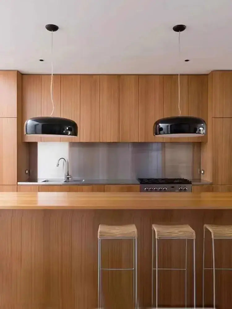Black glossy dome-shaped decorbites italian minimalist round ceiling lamp hanging above wooden kitchen island