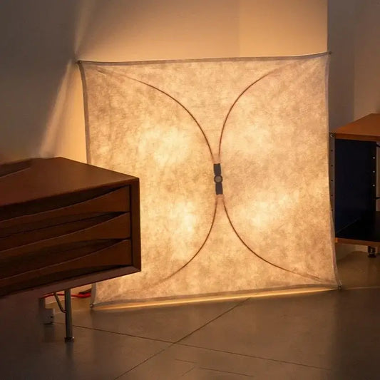 A warm glowing italian vintage ceiling light with beige fabric shade and curved black metal frame for living room decor