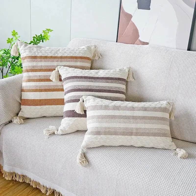 Three rectangular woven pillow cases with tassels in earthy ivory brown coffee tones for decorbites living room decor