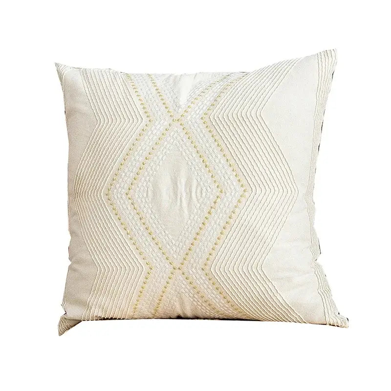 Cream-colored cushion cover with geometric embroidery of stitched diamond shapes for decorbites ivory geometric decor