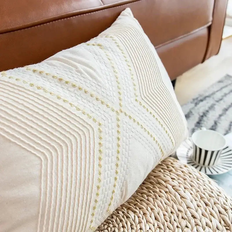 Cream-colored cushion cover with subtle gold geometric embroidery for decorbites ivory geometric living room decor