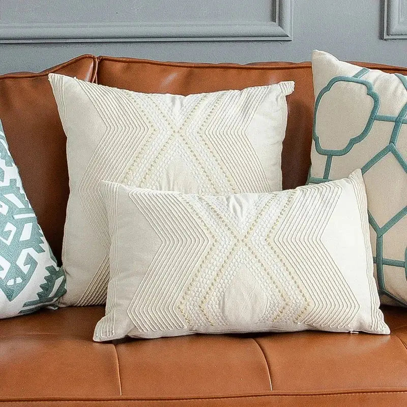 Cream-colored cushion cover with textured geometric embroidery x-shape decorbites ivory geometric living room decor