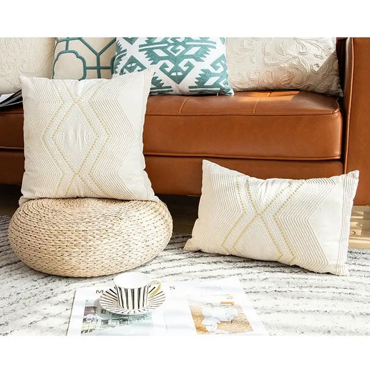 Cream-colored cushion cover with subtle gold geometric embroidery featuring an elegant diamond and arrow pattern decorbites ivory geometric decor