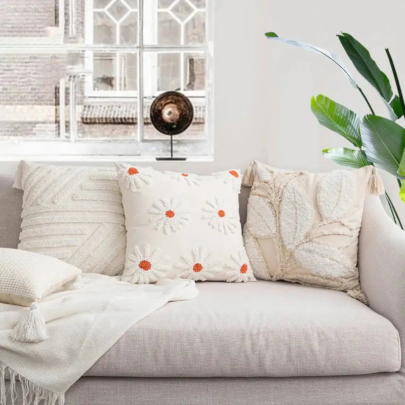 Ivory tufted cushion cover with cream-colored embroidered daisies with orange centers for decorbites ivory tufted decor