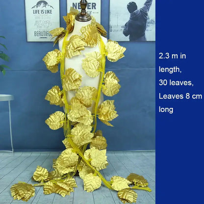 Golden leaf shaped decorative garland vine with shiny metallic finish and yellow string for outdoor door decor