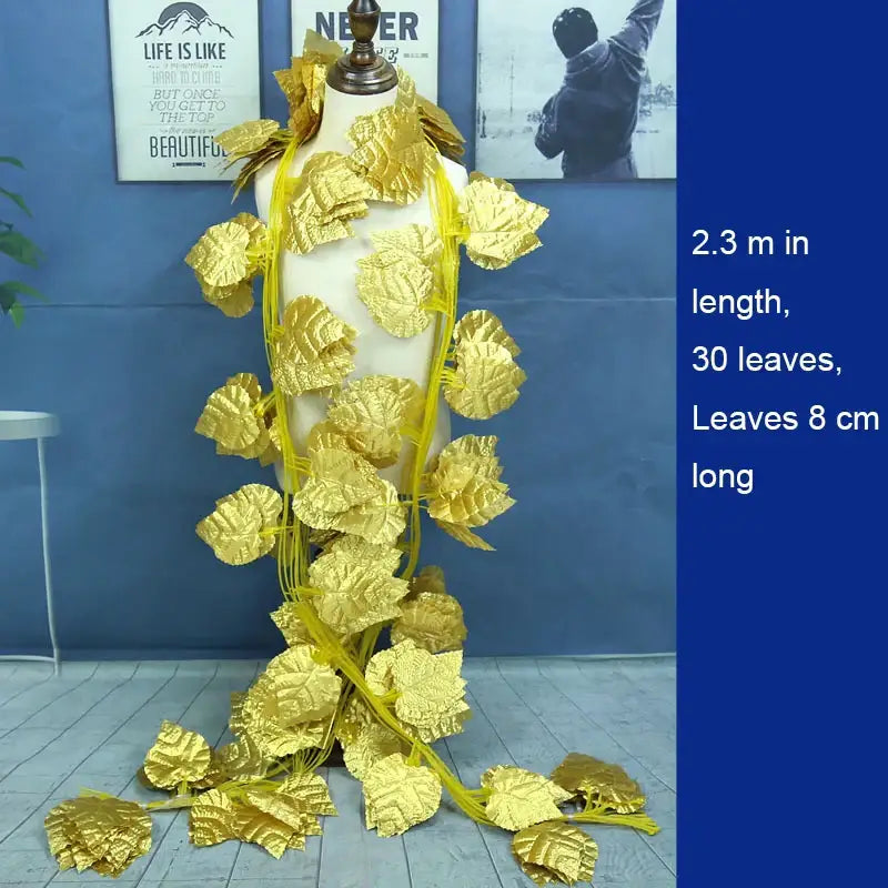 Golden leaf shaped decorative garland vine with shiny metallic finish and yellow string for outdoor door decor