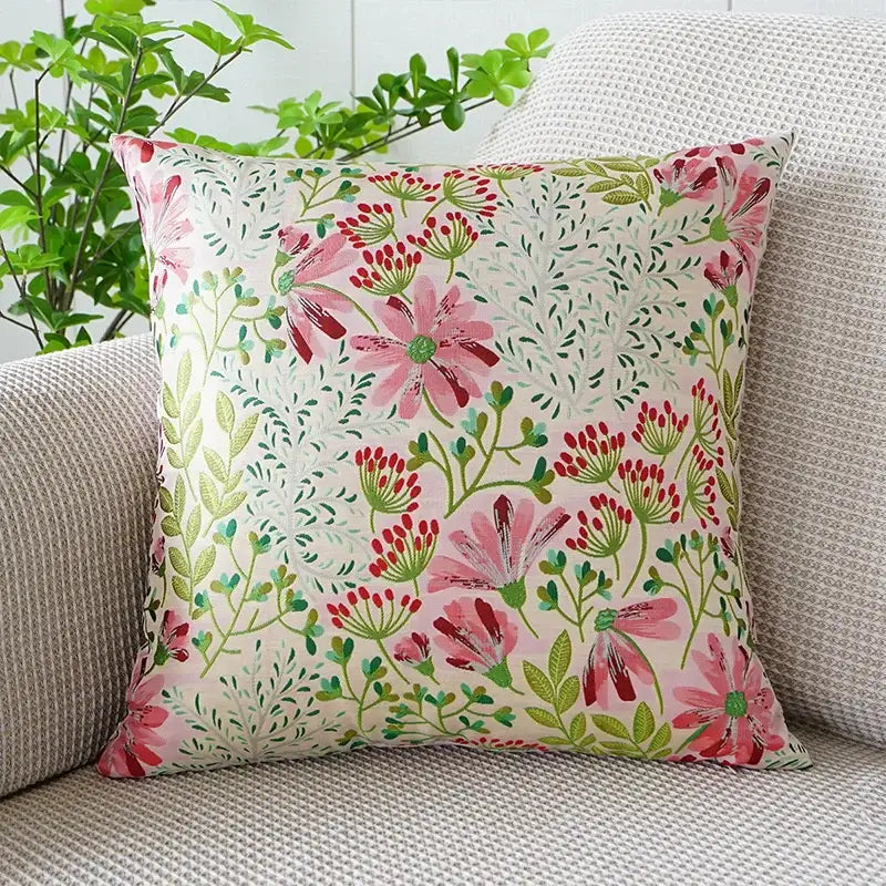 Jacquard floral pillow cover with vibrant pink blossoms green leaves and red buds on an off-white background for bedroom decor