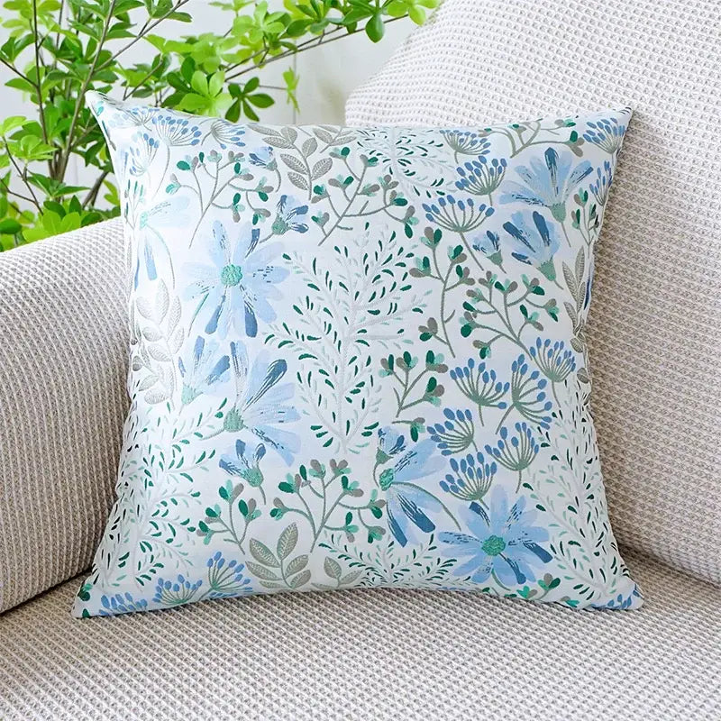A jacquard floral pillow cover with delicate blue and green floral pattern on soft fabric for bedroom decor