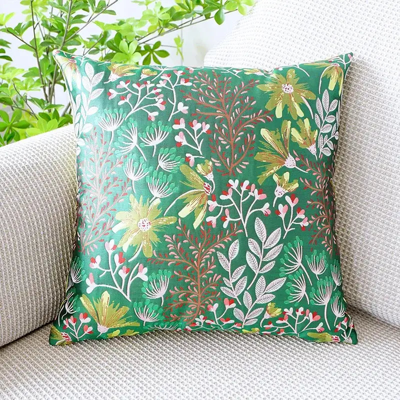Vibrant green jacquard floral pillow cover with detailed yellow white and pink blossoms on satin fabric for bedroom decor