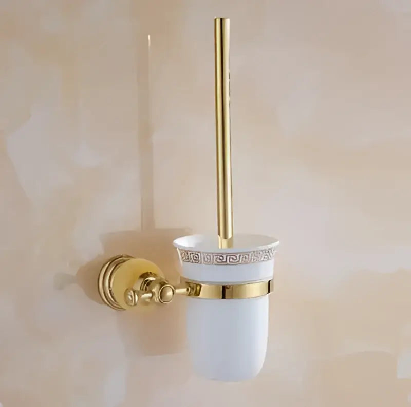 Gold-finished toilet brush holder with white ceramic cup and decorative gold trim in jade gold bathroom accessories set