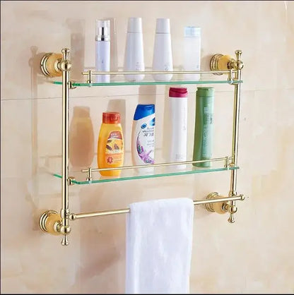 Gold-toned double-tier bathroom shelf with glass shelves and towel bar from jade gold bathroom accessories set