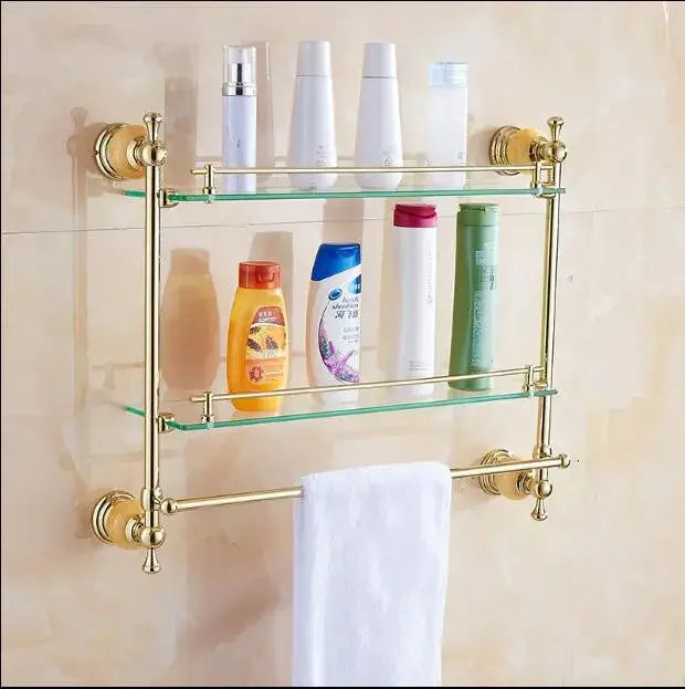 Gold-toned double-tier bathroom shelf with glass shelves and towel bar from jade gold bathroom accessories set
