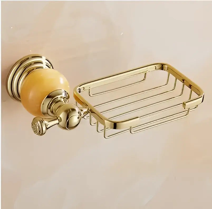 Gold-toned metal soap dish with polished ornate wall mount and amber ceramic knob from jade gold bathroom accessories set