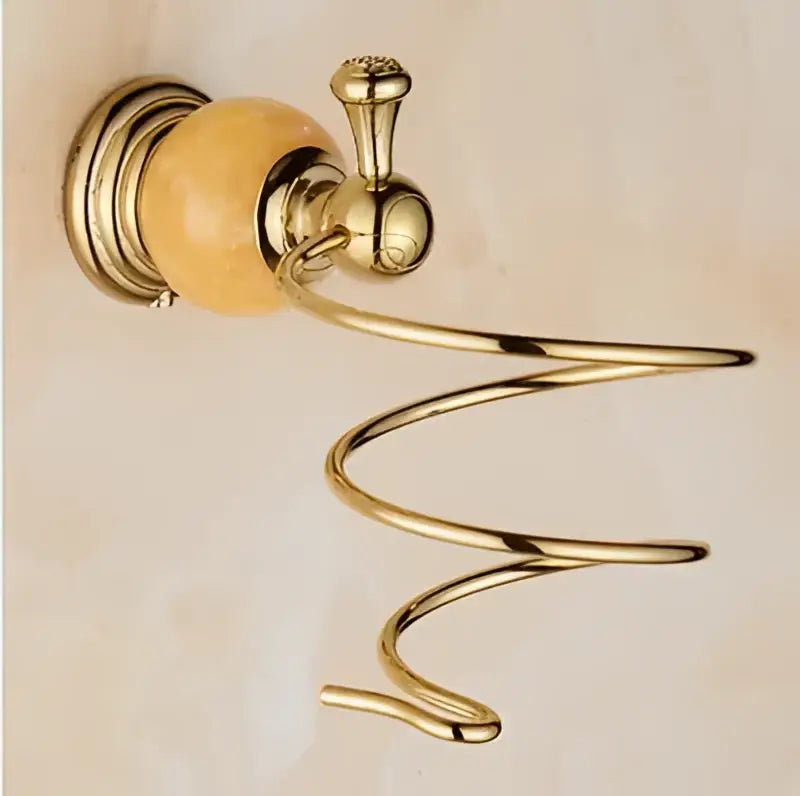 Gold-toned metal towel rack with polished spiral design and amber ceramic knob from jade gold bathroom accessories set
