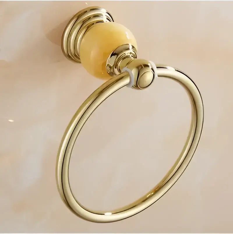 Gold-toned towel ring with polished brass finish and amber ceramic bead from jade gold bathroom accessories set