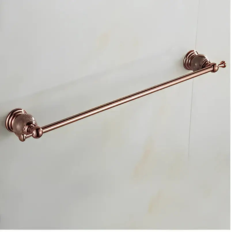 Antique copper-finished bathroom towel rack with ornate decorative end caps in jade rose gold bathroom set